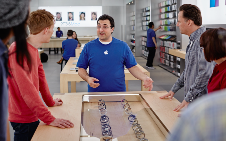 Apple store expert employee speaking to customers