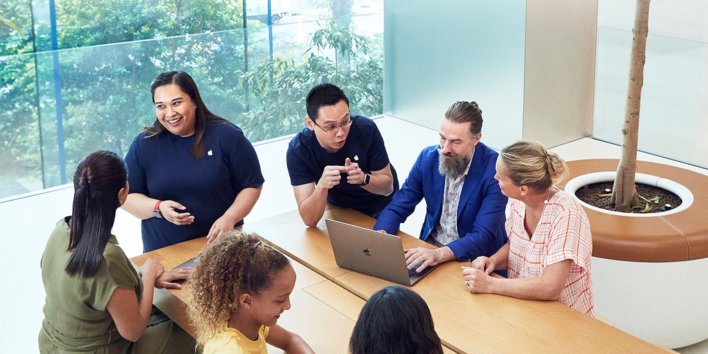 Photo shows Apple Store staff and customers happily interacting around a table | Apple Store unions could represent an opportunity for Apple