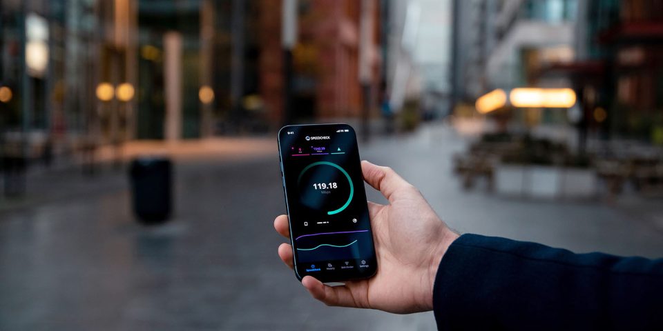 Apple 5G chip | iPhone pictured on city street running 5G speed test