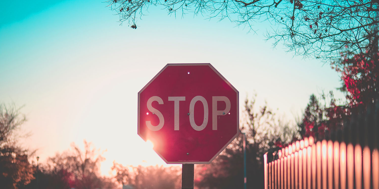Federal privacy law | Stop sign on road with sunset behind