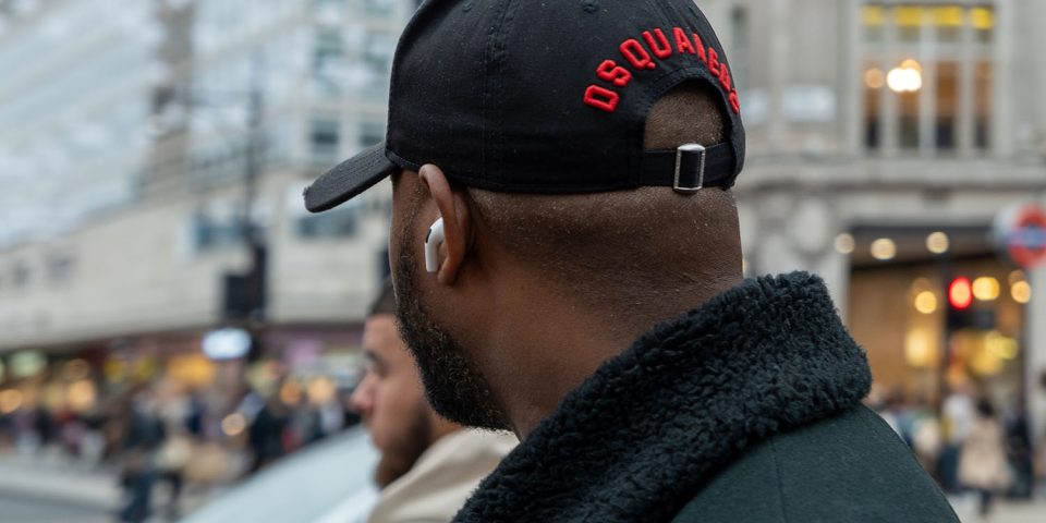 AirPods safety | Man wearing AirPods at busy intersection