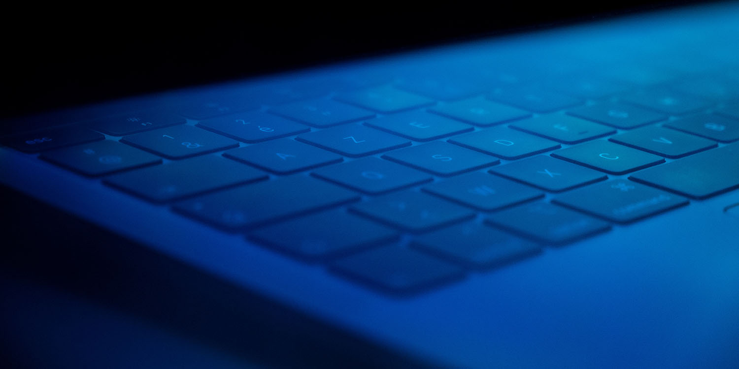 CloudMensis | Mac keyboard under blue lighting