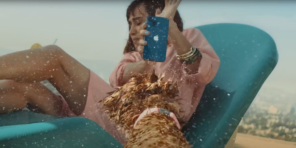 iPhone 13 ads | Dog shakes water over woman and her iPhone 13