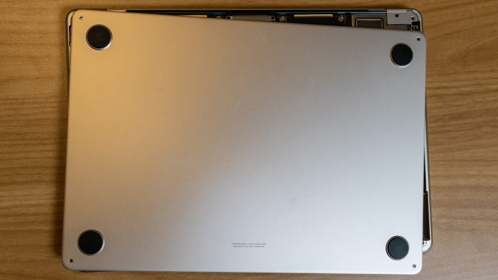 Pull bottom panel towards trackpad to remove latches.