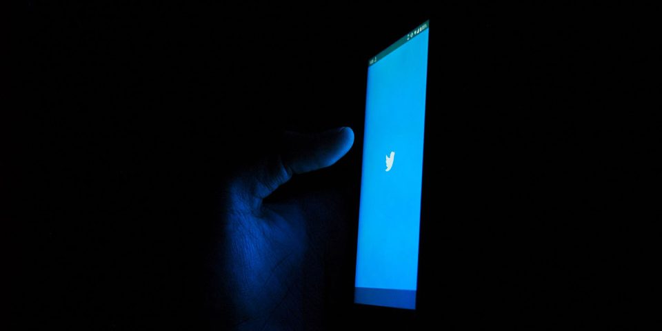 Twitter investigation | Twitter app on smartphone in darkened room
