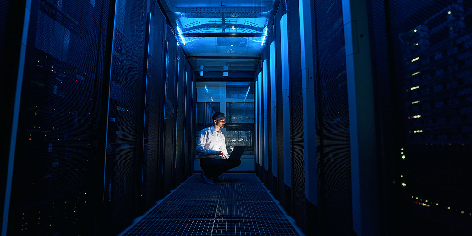 Massive Twitter data breach | Conceptual image of man with laptop in data center