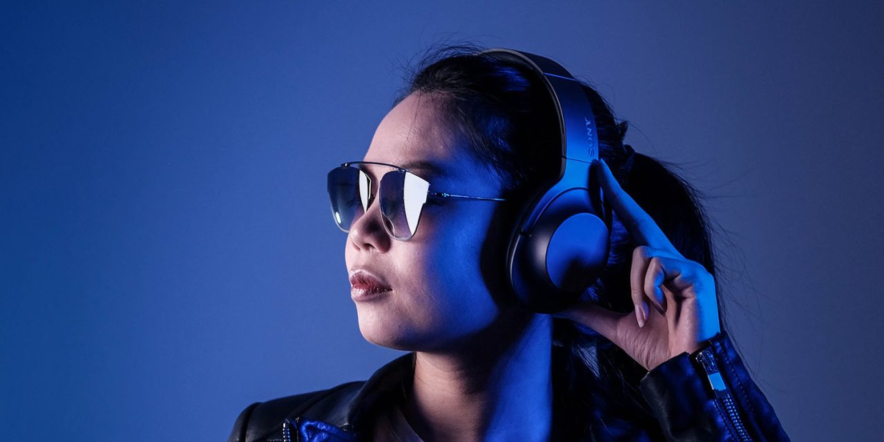 Amazon Music price increase | Woman listening to music through headphones