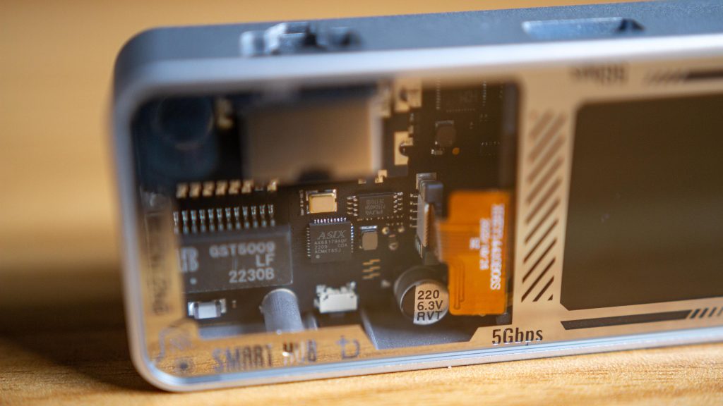 A view of the ethernet port and screen, as well as some internal components on the hubs black circuit board. 