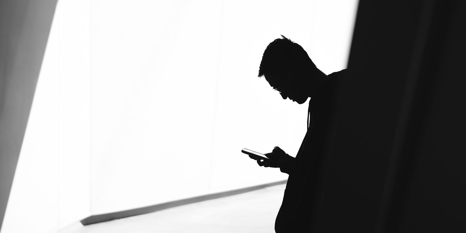 Phone addiction | Silhouette of man using phone