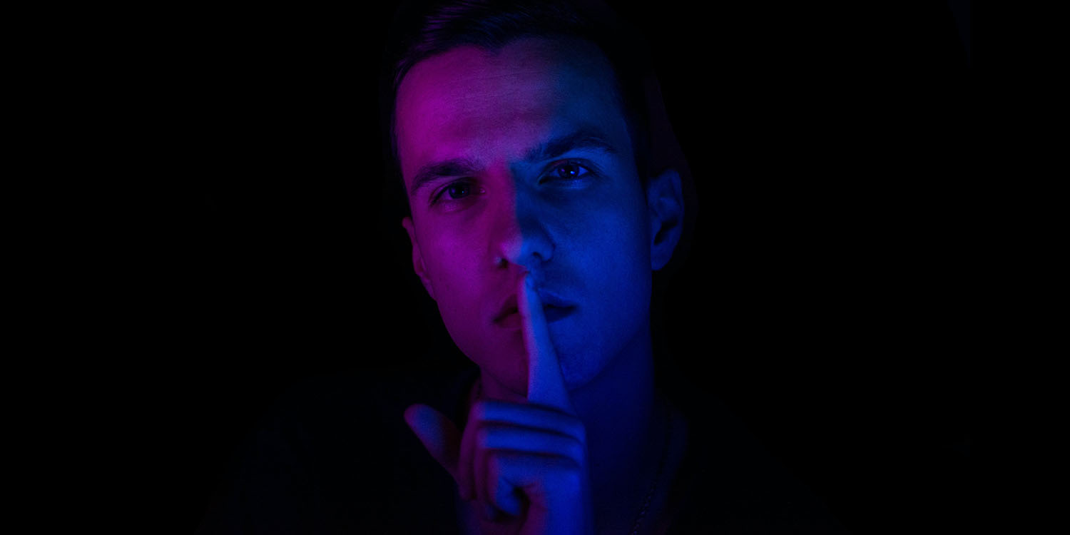 T-Mobile security breach | Man raising finger to lips