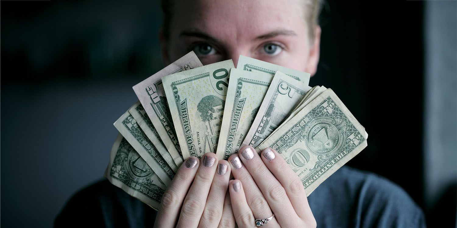 Data brokers | Woman offering dollar bills