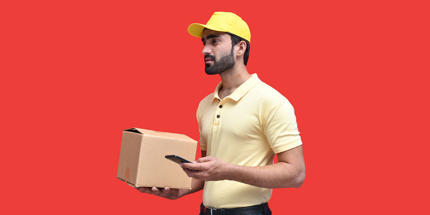 Returning packages via Uber | Delivery driver with package and smartphone