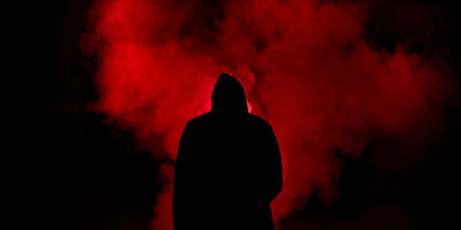 The law doesn't allow Apple to threaten Epic | Abstract image of man silhouetted against red smoke