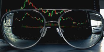 AAPL Q2 earnings likely to be $5B down | Trading graph viewed through eyeglasses