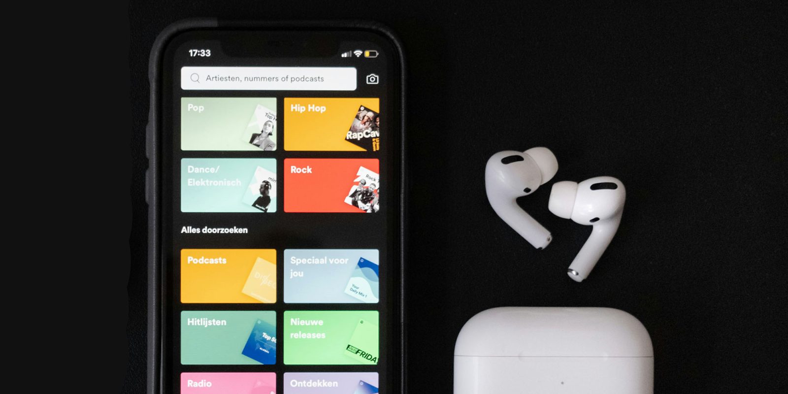Apple fights $2B antitrust fine | Spotify on iPhone screen, with AirPods