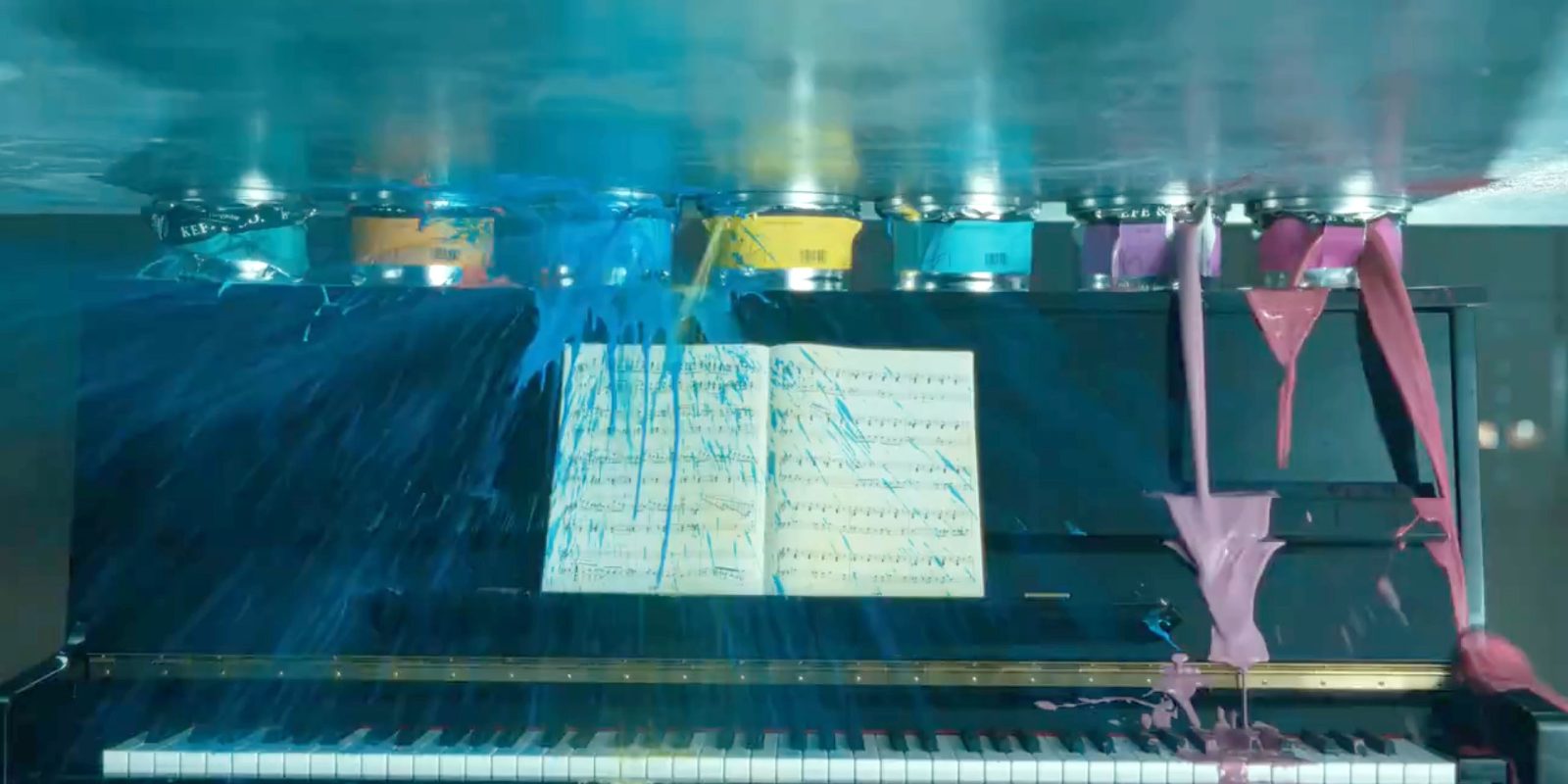 Still image from an iPad Pro ad, showing paintings being crushed and ruining a piano