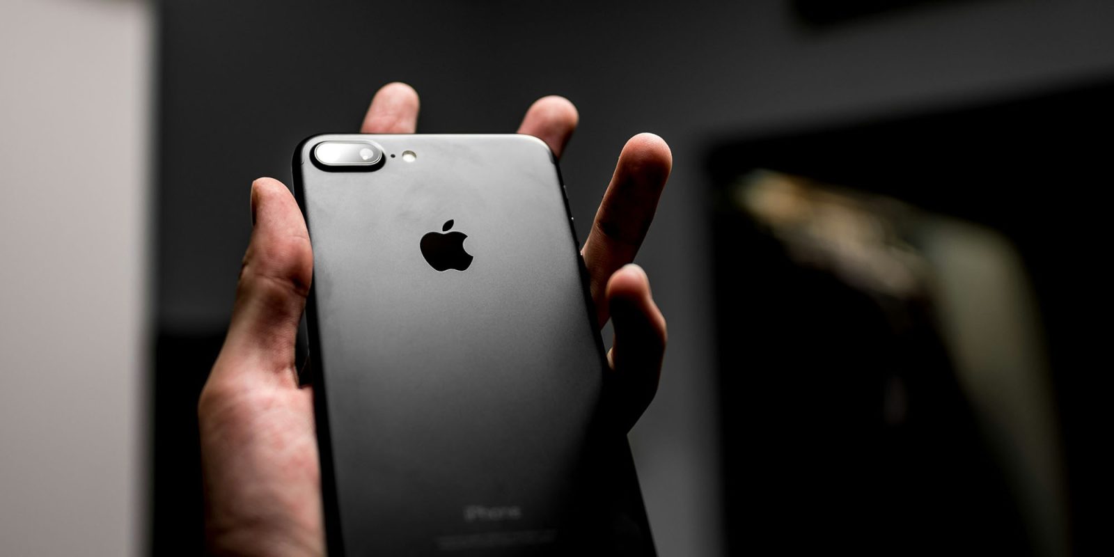 Apple warns of mercenary spyware attacks | Low-key photo of iPhone