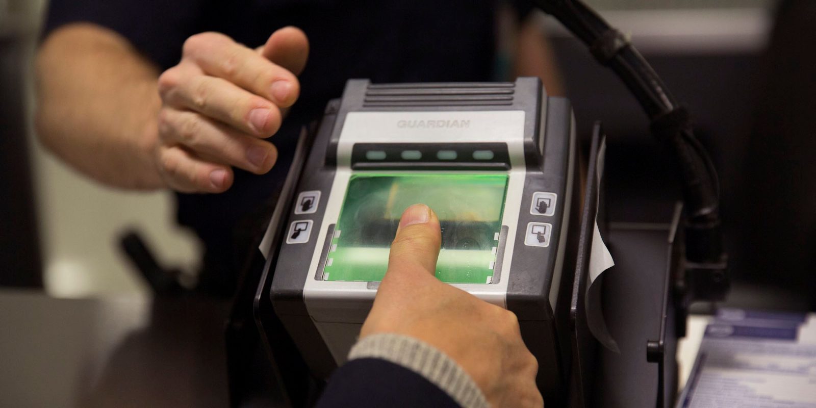 Border agents cannot search smartphones without a warrant | CBP agent taking fingerprint