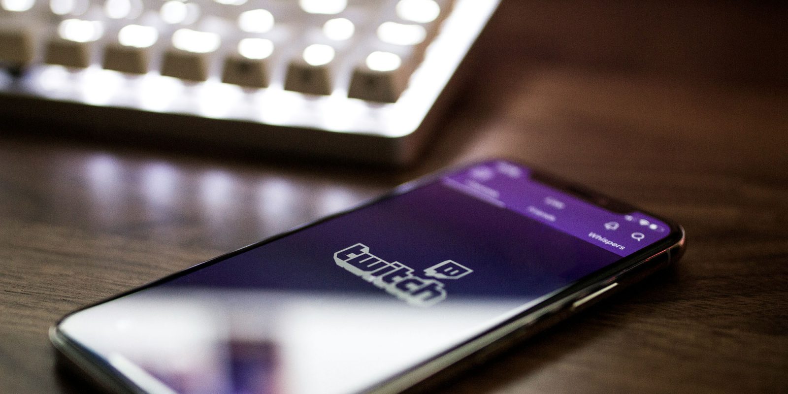 Twitch subscriptions rising again | App shown on iPhone next to keyboard