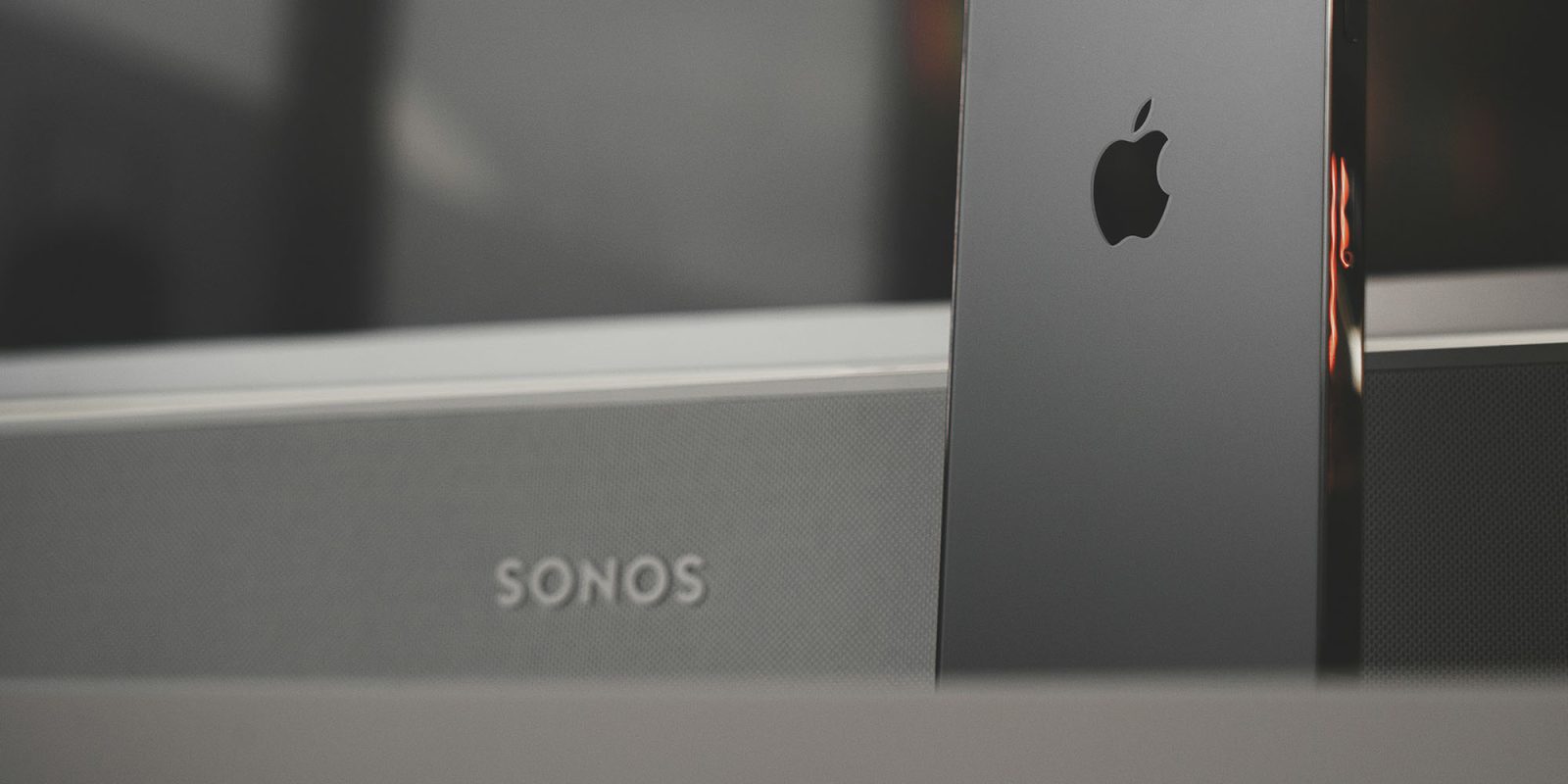 Two new Sonos products ready to ship, but delayed | Sonos soundbar seen behind iPhone