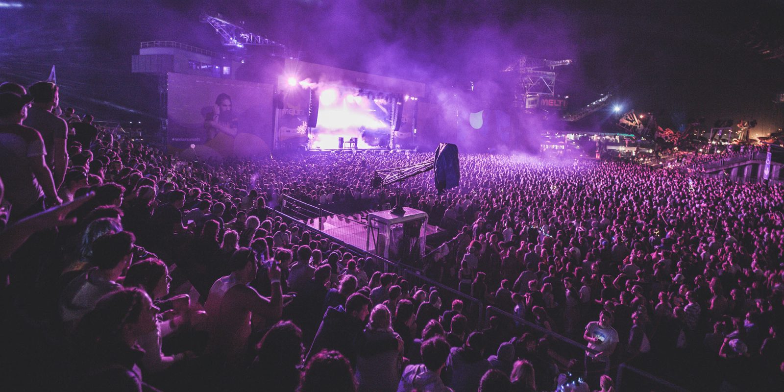 FTC bans bait-and-switch pricing from hotel and concert apps | Photo shows concert with purple lighting