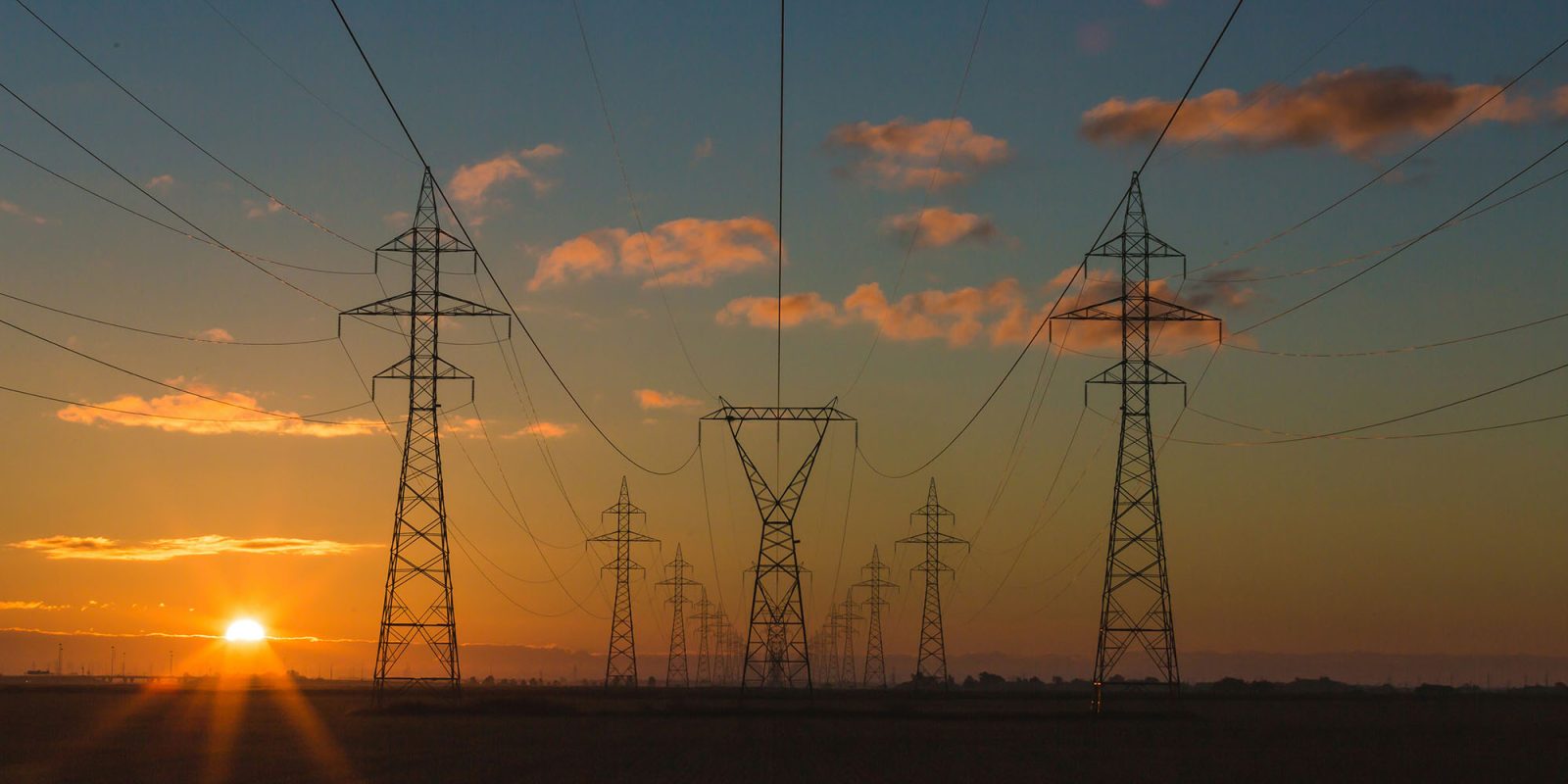 Huge growth in AI usage could cause electricity blackouts in US and Canada next year | Electricity pylons at sunrise