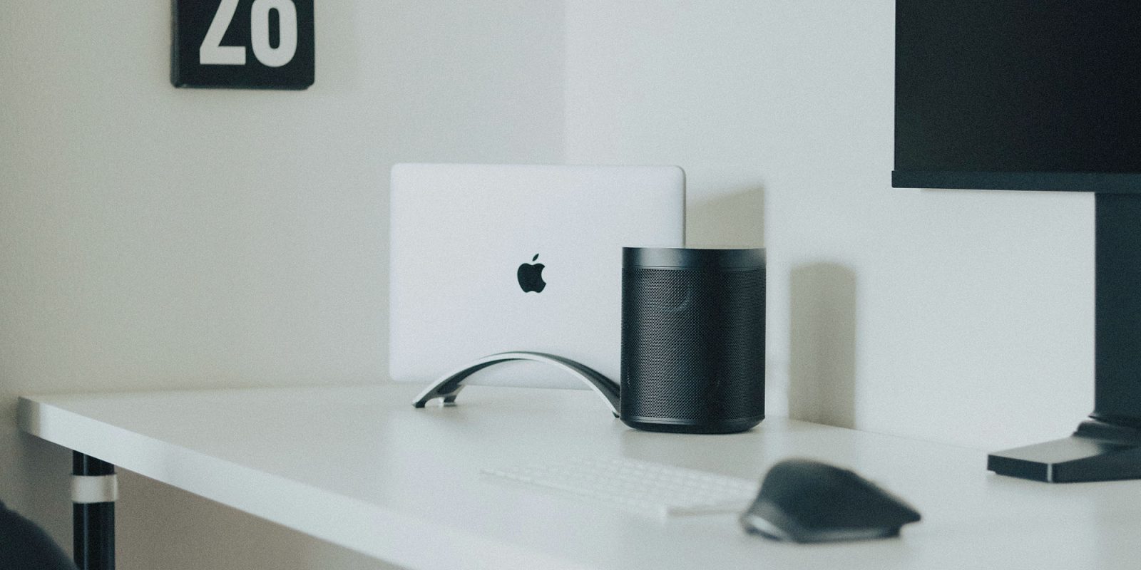 Users fear the Sonos app could require a subscription | Sonos speaker on a desk with a MacBook