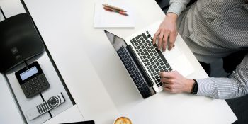 Hyper-personalized phishing attacks, powered by AI | Man typing on MacBook