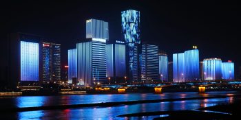 iPhone drops from 1st to 3rd place in China, as Apple struggles to launch AI features | Riverside buildings at night in Fuzhou, China