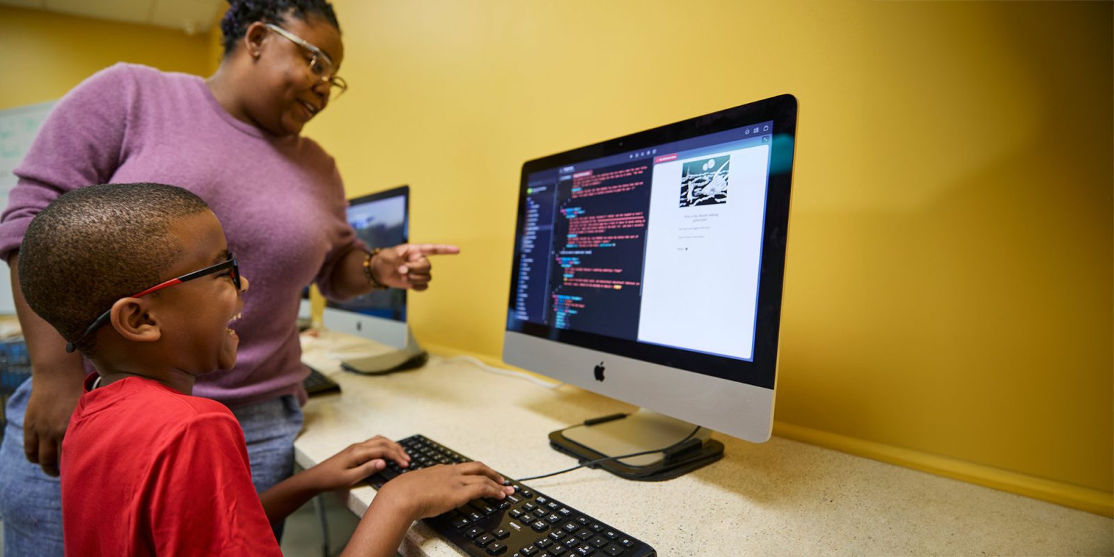 Apple explains why it requires New Orleans music students to learn coding | A student and teacher working in a coding class