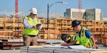 Amazon and Apple best deliver on affordable housing promises, as other tech giants falter | Construction workers study plans