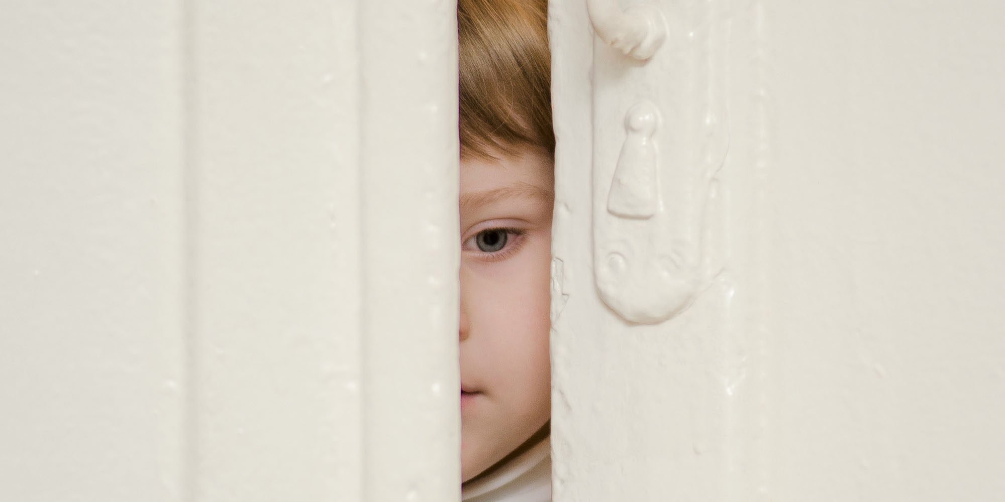 Roblox is requiring kids as young as nine to submit a video selfie for age verification | Photo of a child peeking out through a partly open doorway