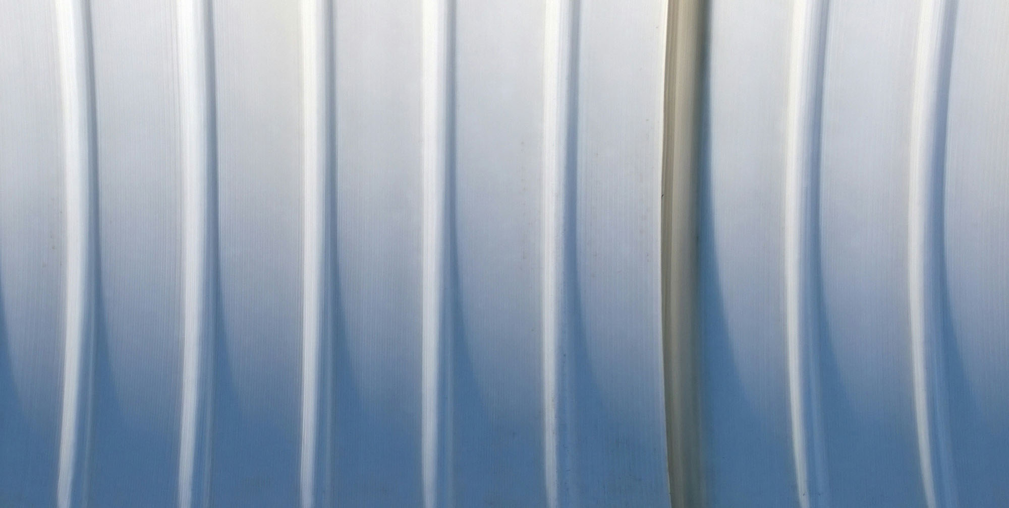 Apple shared 'bendgate' lessons as it helped small US manufacturers innovate | Abstract image of bent lines