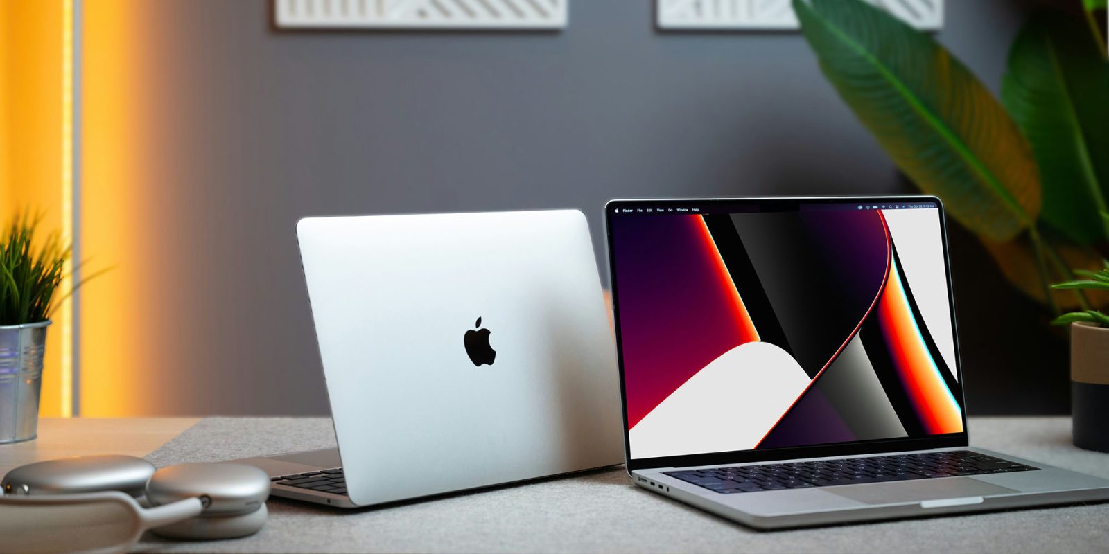 Best Buy worker allegedly gave himself a 99% discount on MacBooks and more | Two MacBooks seen on a desk with a pair of AirPods Max