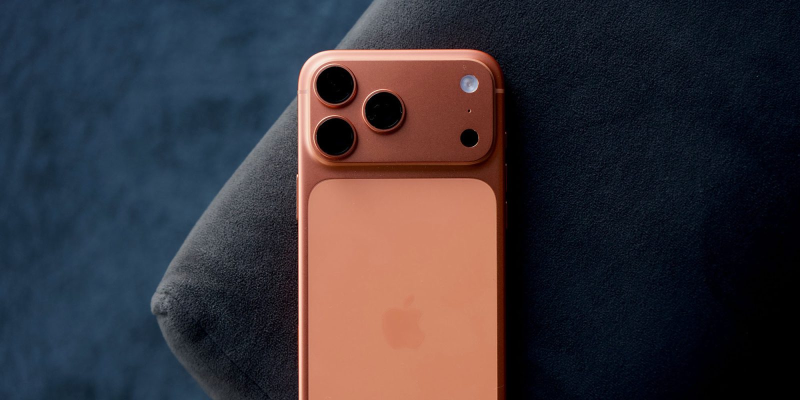 Two reasons helped Apple hit record iPhone sales, and they're both orange | Photo shows iPhone 17 Pro Max in Cosmic Orange