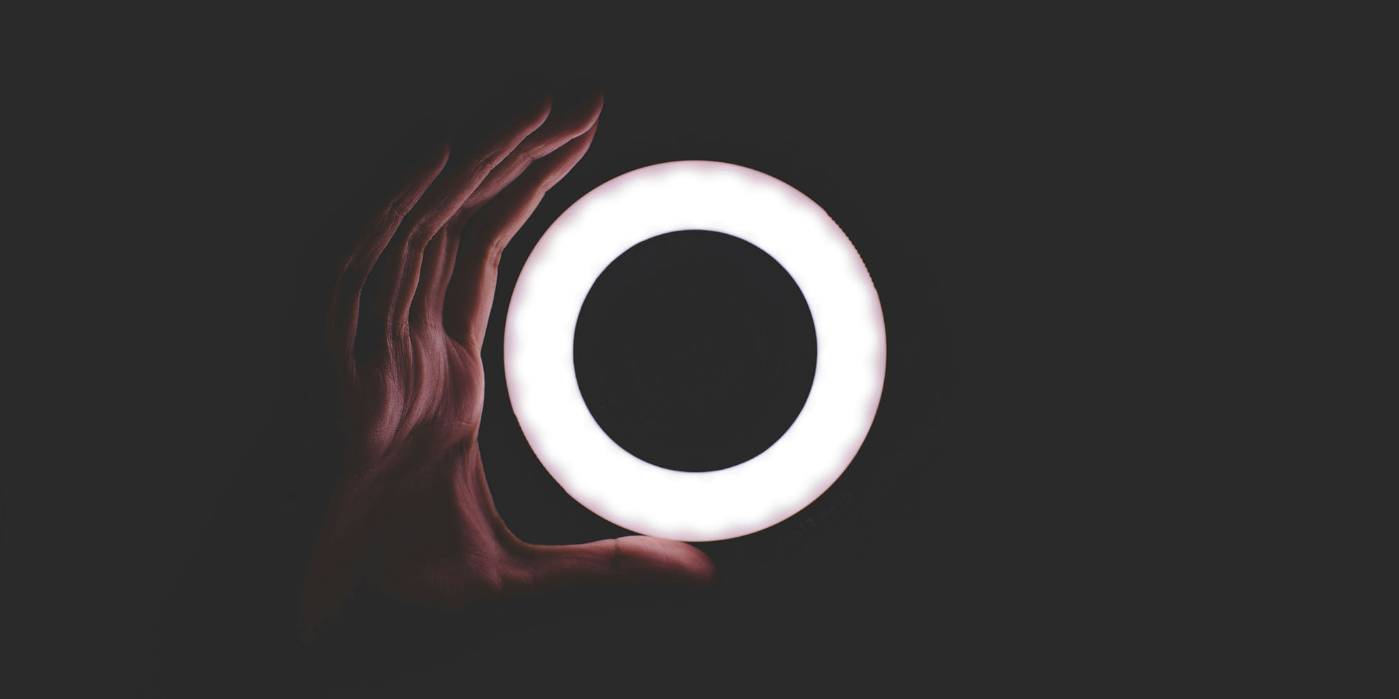 iPhone Diary: The camera let me shoot video in near-impossible conditions | Photo shows a hand with a small ring light in the pitch black