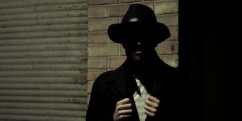 Judge blocks White House from 'strong-arming' Apple into blocking ICE trackers | Stock photo shows a shadowy figure representing the mob