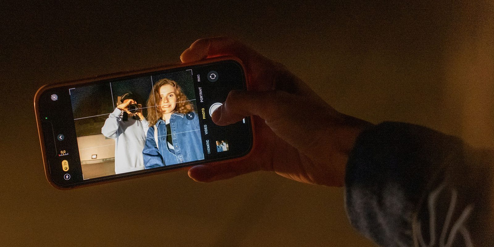 This could be the best thing to ever happen to Apple's Camera app | Image shows someone taking a photo on an iPhone with controls visible on the screen